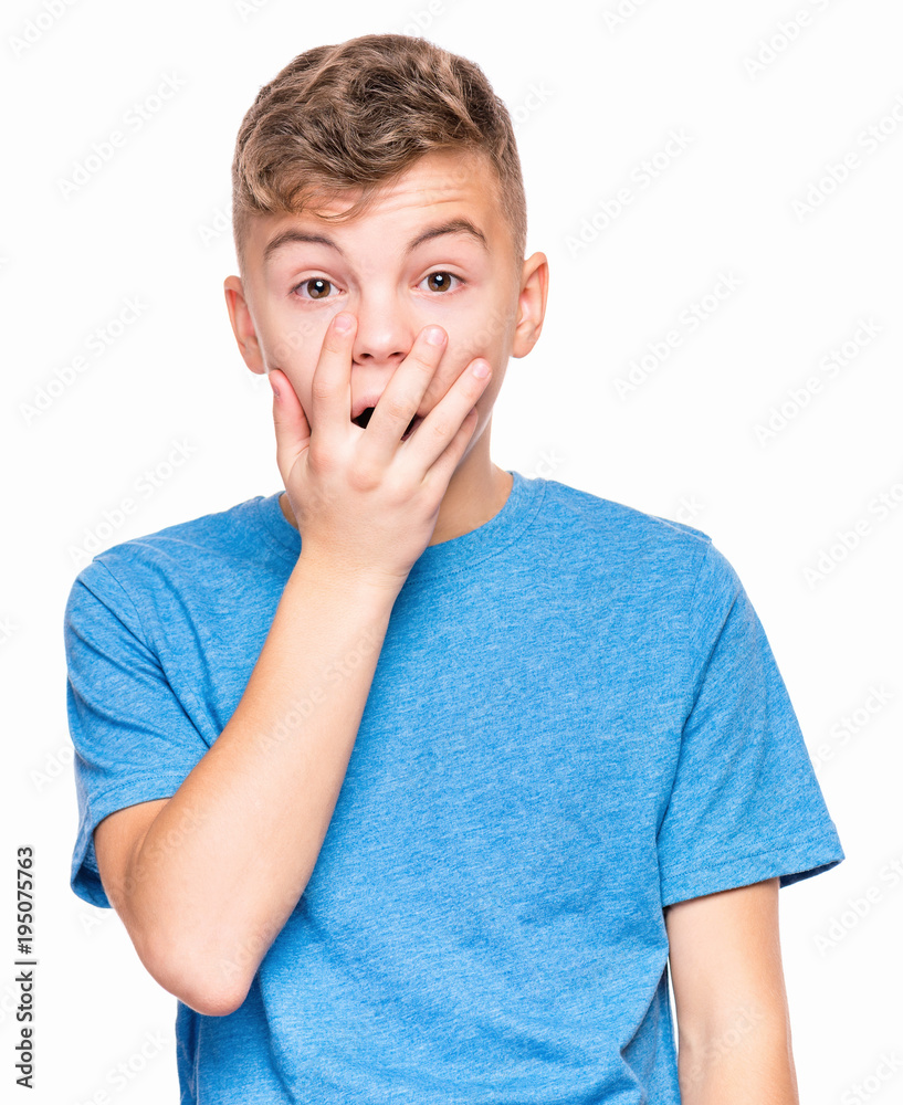 Emotional portrait of caucasian teen boy wearing blue t-shirt. Surprised or scared teenager looking at camera. Handsome child, isolated on white background. Emotional portrait of caucasian teen boy wearing blue t-shirt. Surprised or scared teenager looking at camera. Handsome child, isolated on white background.
