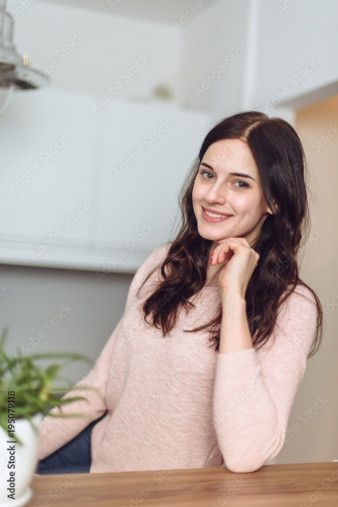 Smiling attractive woman having breakfast in kitchen interior. Smiling attractive woman. Smiling attractive woman having breakfast in kitchen interior. Smiling attractive woman.