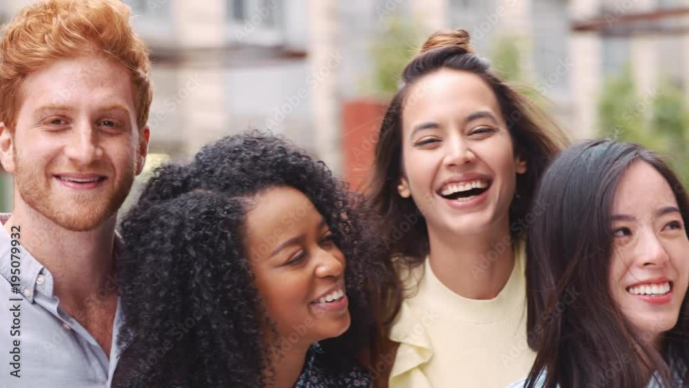 Happy young colleagues outside their workplace, close up
