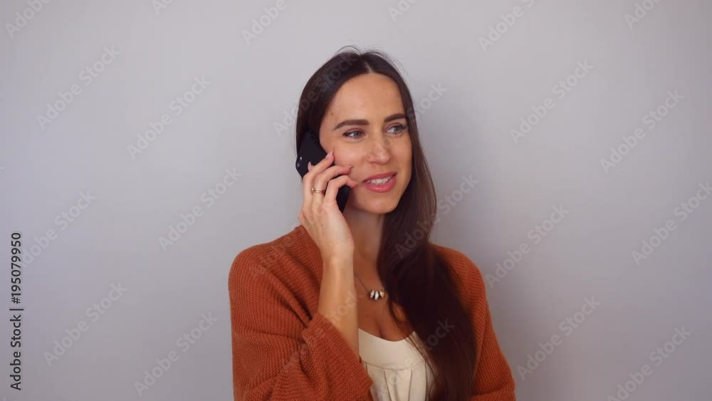 woman has a call in a pleasant manner while talking with somebody woman has a call in a pleasant manner while talking with somebody