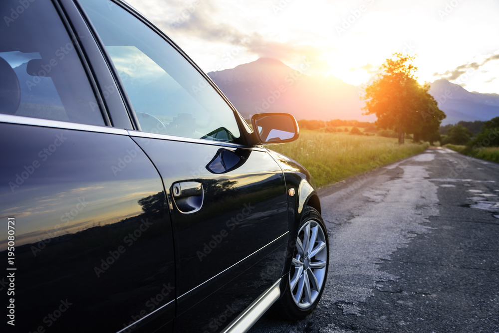 Car on a country road in the rays of the sun. Car on a country road in the rays of the sun.