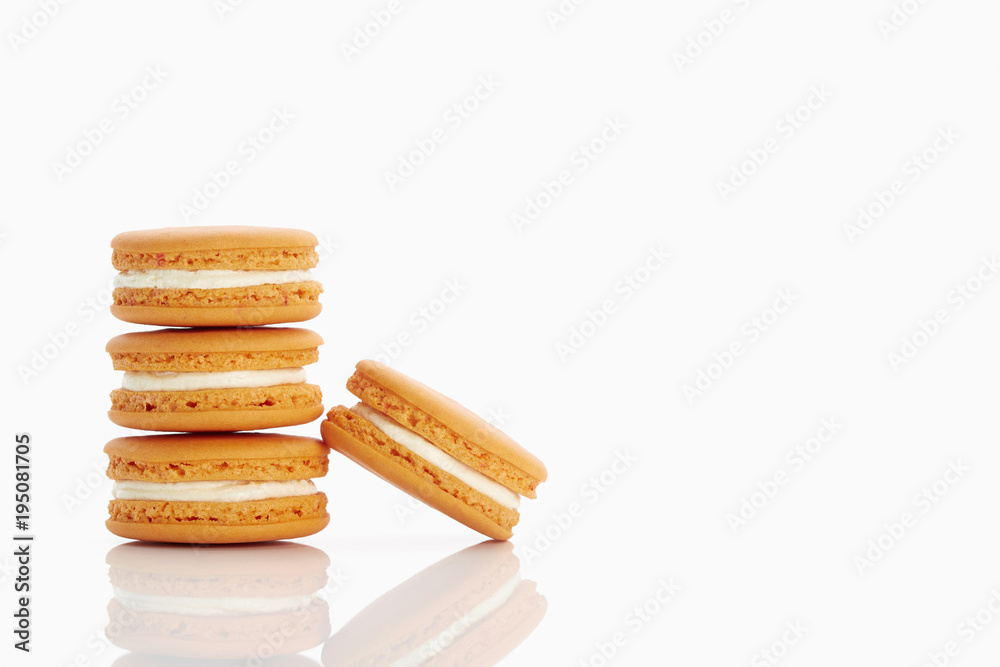 Assorted macaroons over white background with reflection. Assorted macaroons over white background with reflection.