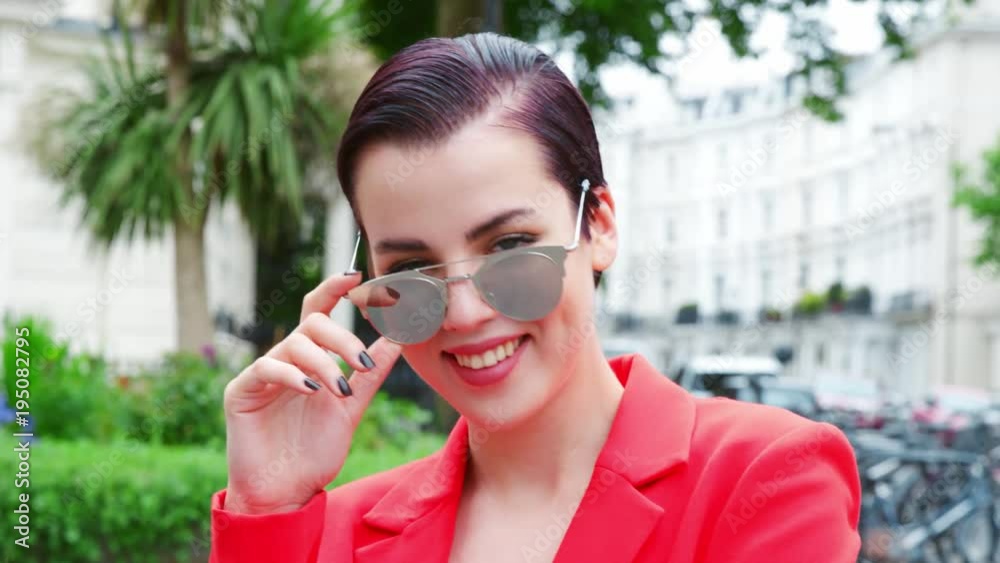 Stylish Woman Wearing Sunglasses Standing On City Street Stylish Woman Wearing Sunglasses Standing On City Street