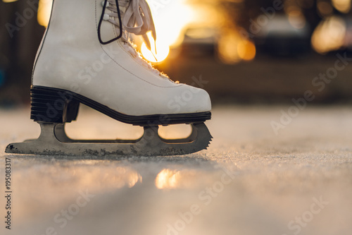 Close-up of woman skating on ice. Close-up of skates and ice. Side view. © Jan Rozehnal