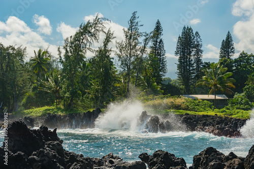 coastal view of the shore line with its black volcanic rocks and cliffs at hana maui hawaii