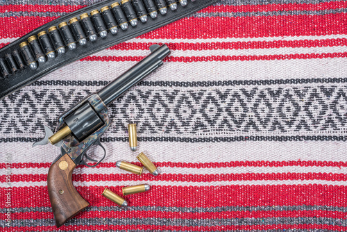 Single Action Revolver Reloading Bullets with Gunbelt and Mexican Blanket photo