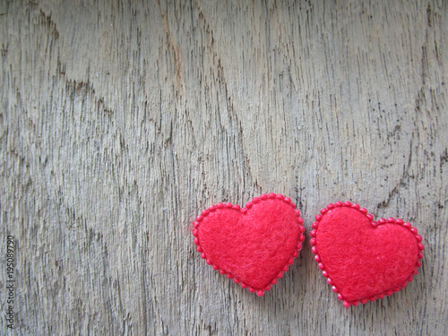 Two red heart on wood background