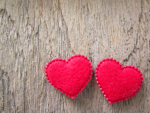 Two red heart on wood background