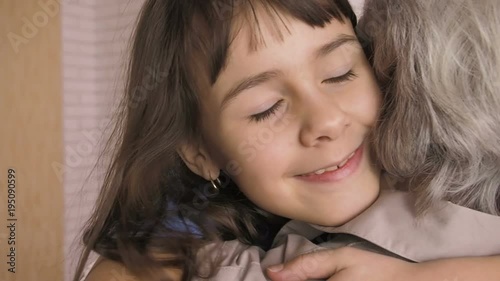 Grandmother with granddaughter. A little girl hugs her grandmother. photo