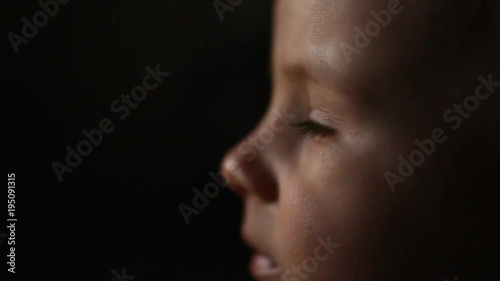 Captivated baby lost at television, TV education, tired boy portrait expression