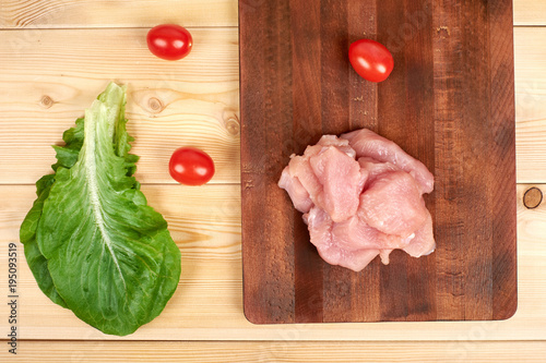 Turkey raw breast pieces on a cutting board wooden background photo