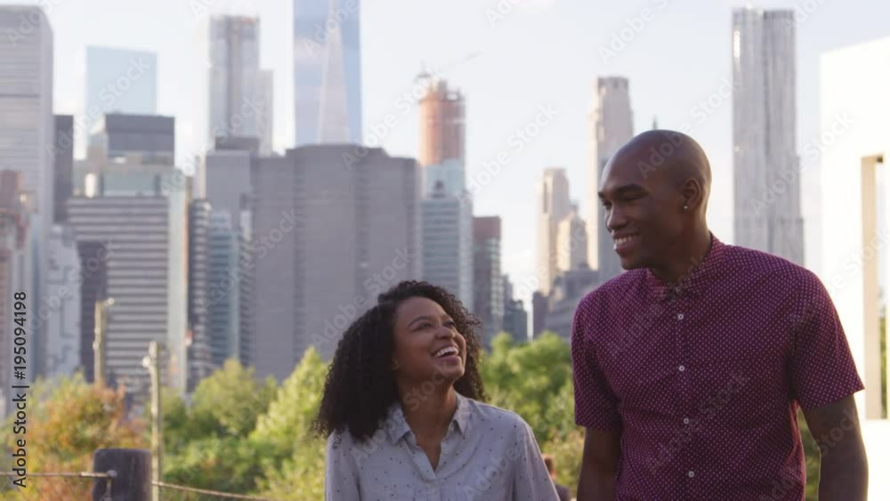 Couple Visiting New York With Manhattan Skyline In Background