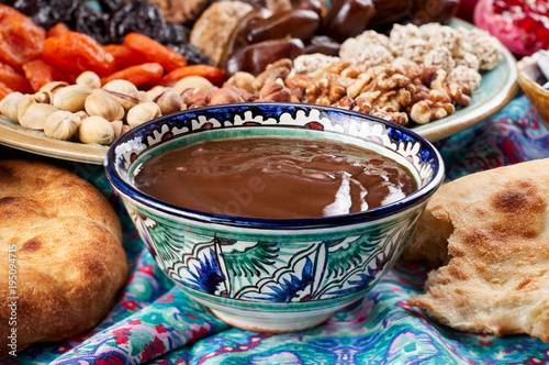 Traditional Azerbaijan sweet cuisine of holiday Nowruz: national dessert Sumalak, assortment of nuts and dry fruits