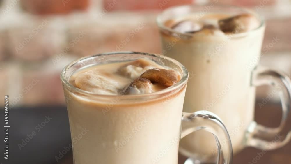 Iced coffee in glass jars on the table. Iced coffee in glass jars on the table.