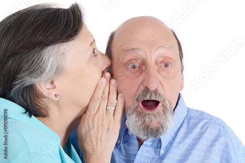Portrait of elderly couple whispering
