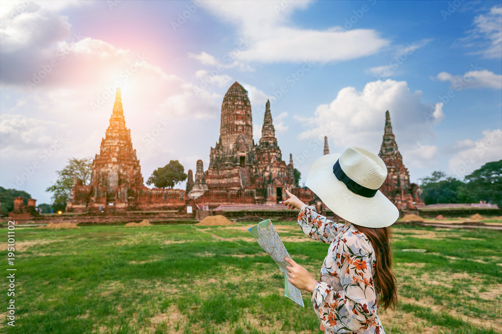 Fototapeta premium Young girl at Ayutthaya Historical Park, Wat Chaiwatthanaram Buddhist temple in Thailand.