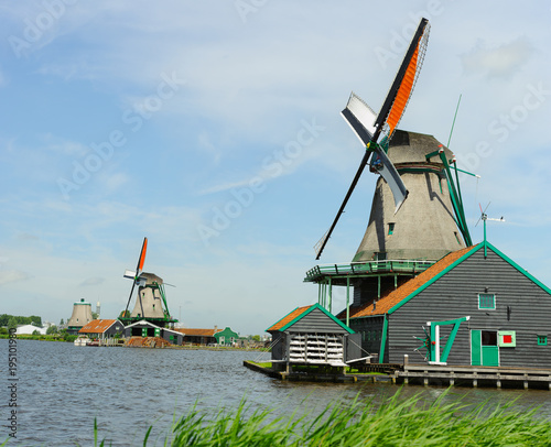 Traditional dutch windmill near the canal in summer day. Netherlands