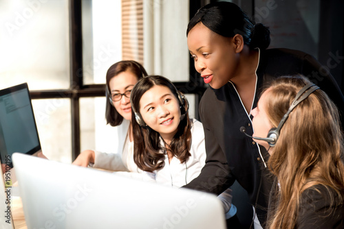 Black female supervisor working with colleagues in call center photo