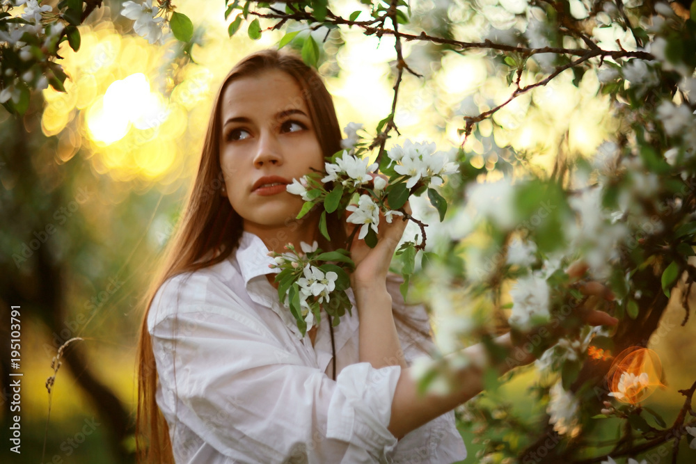 Fototapeta premium Beautiful in flowers girl young adult concept of spring
