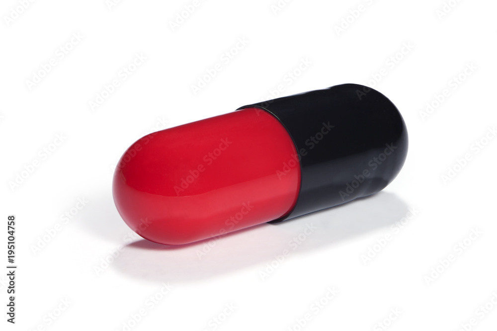Red and black capsule with medicine on a white background Red and black capsule with medicine on a white background