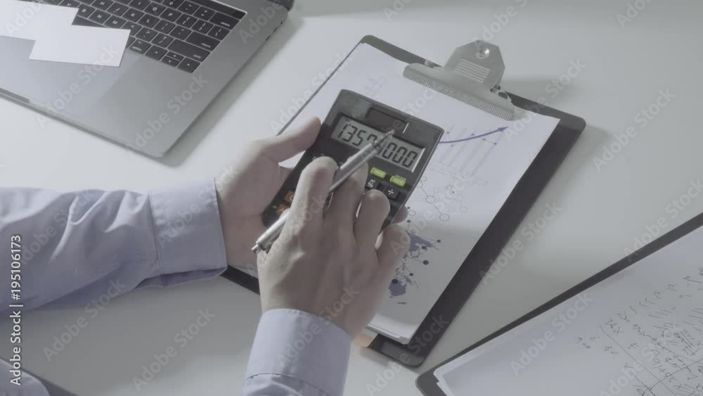businessman hand working with finances about cost and calculator and laptop with mobile phone on withe desk in modern office
businessman hand working with finances about cost and calculator and laptop with mobile phone on withe desk in modern office