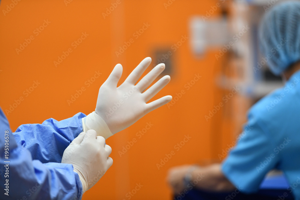 Surgeon hand putting on a grove and preparing for a surgery