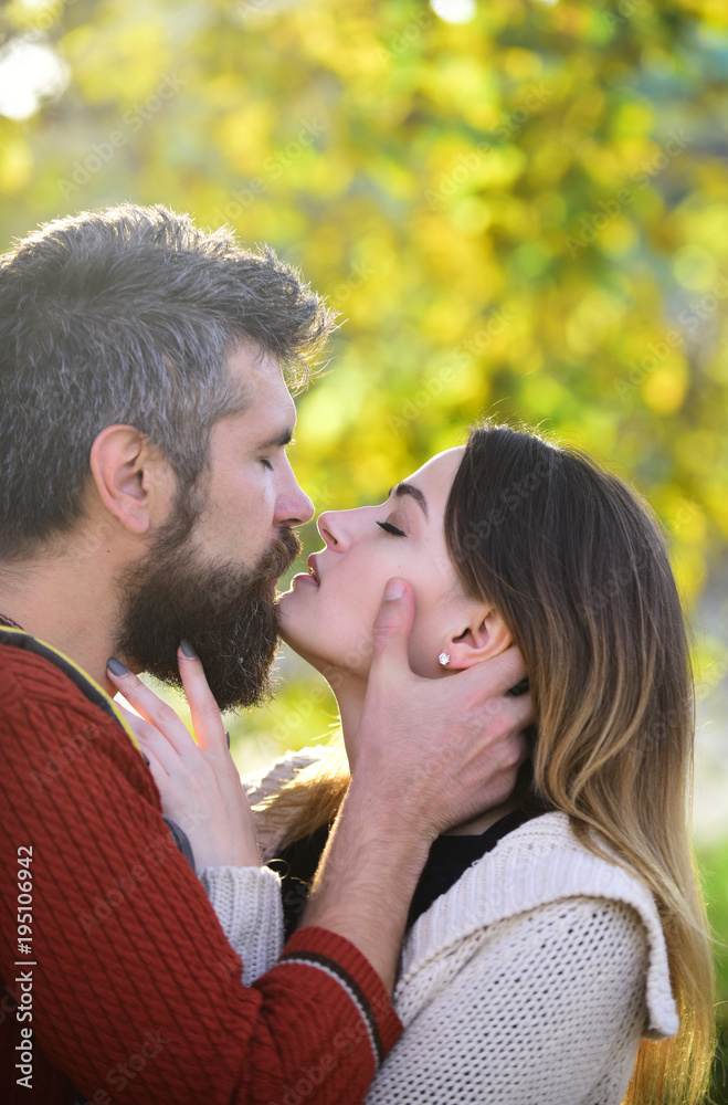 Man with beard holds womans head with tenderness, close up. Man with beard holds womans head with tenderness, close up.