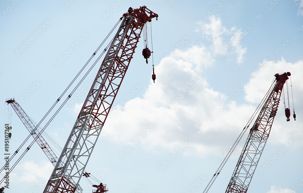 A crane of a sunny blue sky building site A crane of a sunny blue sky building site