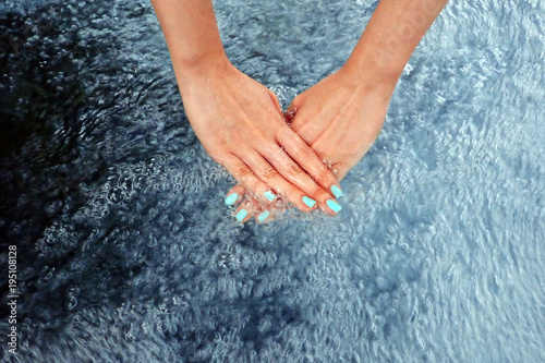 Green Finger Nails Manicure Isolated in The Water. Top View. Beautiful Woman is hand and Fingernails in Bubble Water Background Great For Any Use.