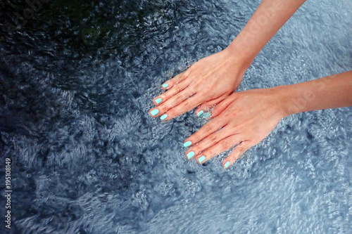 Green Finger Nails Manicure Isolated in The Water. Top View. Beautiful Woman is hand and Fingernails in Bubble Water Background Great For Any Use.