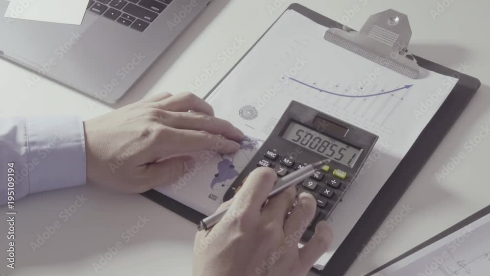 businessman hand working with finances about cost and calculator and laptop with mobile phone on withe desk in modern office
businessman hand working with finances about cost and calculator and laptop with mobile phone on withe desk in modern office