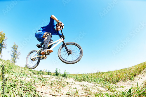 cyclist riding jumping with bicycle cross-country
