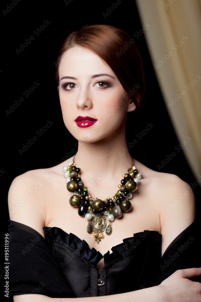 Fototapeta premium Portrait of a beautiful style redhead girl with necklace