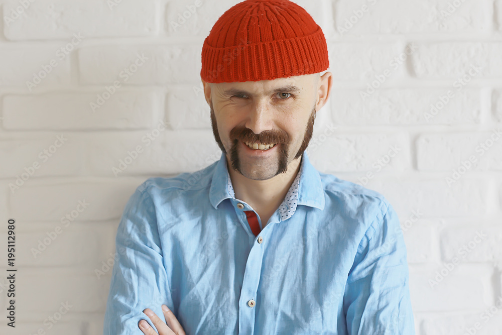guy with a mustache in a red knitted hat