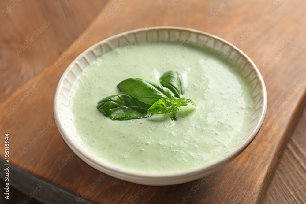 Tasty creamy sauce for fish taco in bowl on wooden table Tasty creamy sauce for fish taco in bowl on wooden table