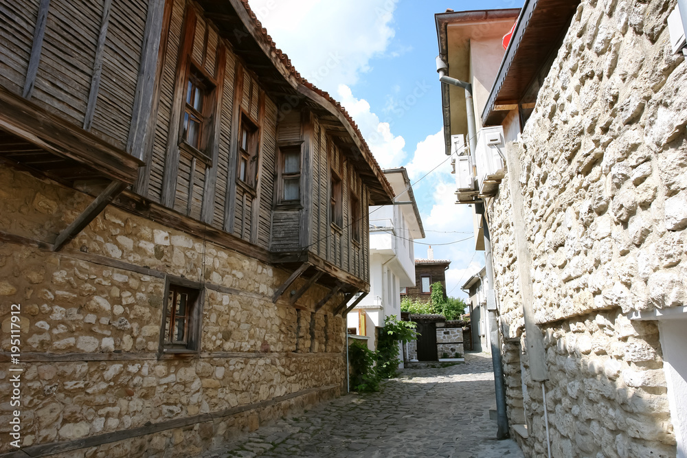 A street with traditional Bulgarian wooden houses in the old Nessebar.