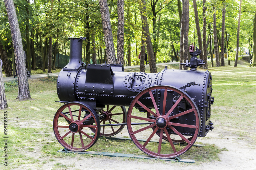 Restored steam engine for agricultural works. A historical monument of the nineteenth century, standing in the city park. Podlasie, Poland.