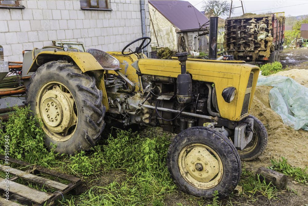 An old tractor designed for various works on an agricultural farm. An open cabin. Late autumn. Podlasie, Poland. An old tractor designed for various works on an agricultural farm. An open cabin. Late autumn. Podlasie, Poland.