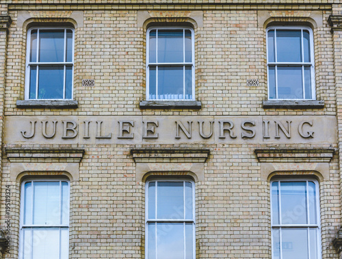 Facade with Jubilee Nursing Carved in the Wall  Split Toning Shallow Depth of Field Architecture Details