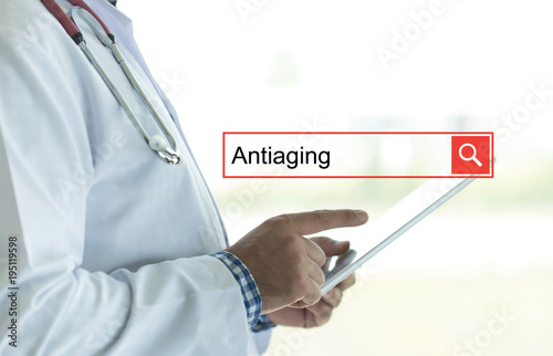 DOCTOR USING TABLET PC AND SEARCHING ANTIAGING ON WEB