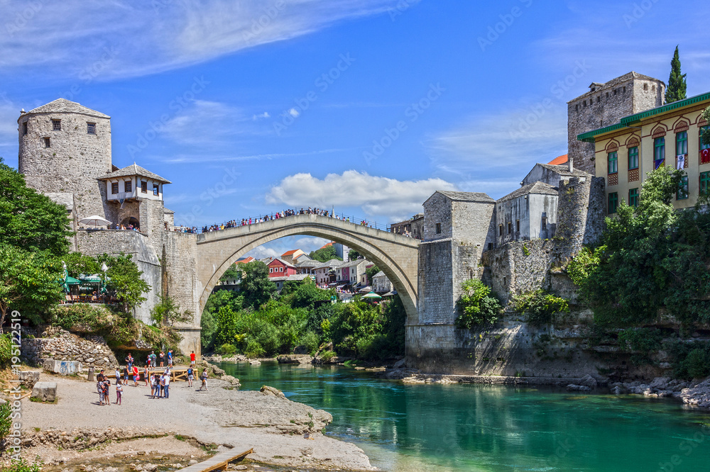 Mostar, Bosnia and Herzegovina. Tourists near Mostar Old bridge - Bosnian landmark.