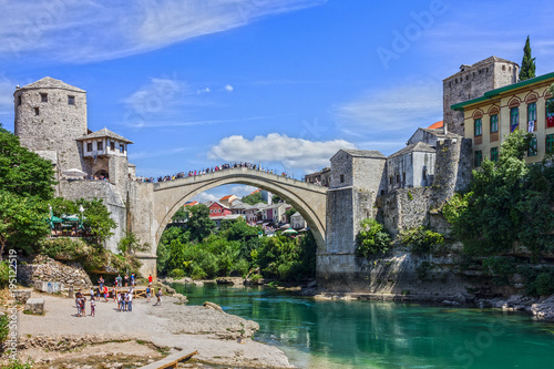 Mostar  Bosnia and Herzegovina. Tourists near Mostar Old bridge - Bosnian landmark.