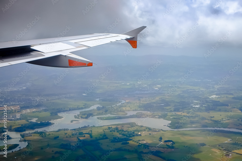 Beautiful landscape green field views from an airplane window during landing at Auckland International Airport, New Zealand. Beautiful landscape green field views from an airplane window during landing at Auckland International Airport, New Zealand.
