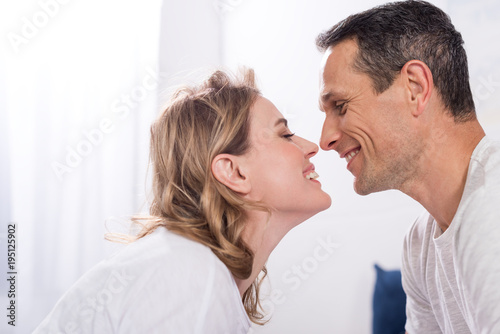side view of happy couple in love looking at each other at home