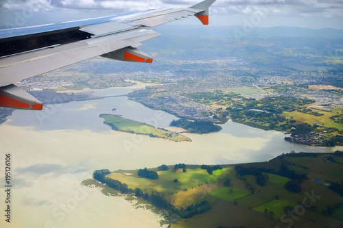 Beautiful landscape green field views from an airplane window during landing  at Auckland  International Airport,  New Zealand.