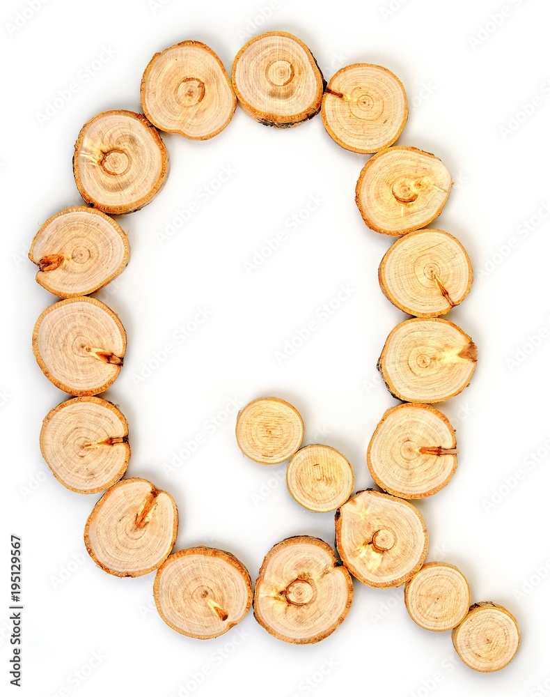 Alphabet letters made from Wood slice on white Background.Q. Alphabet letters made from Wood slice on white Background.Q.