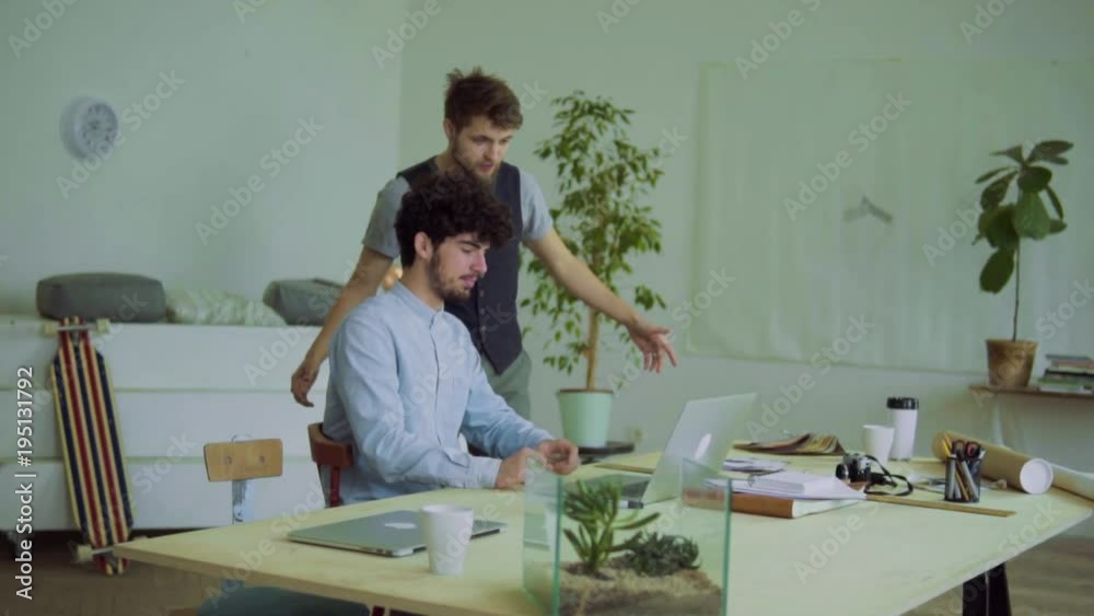 Young men celebrating success in an office. Young men celebrating success in an office.