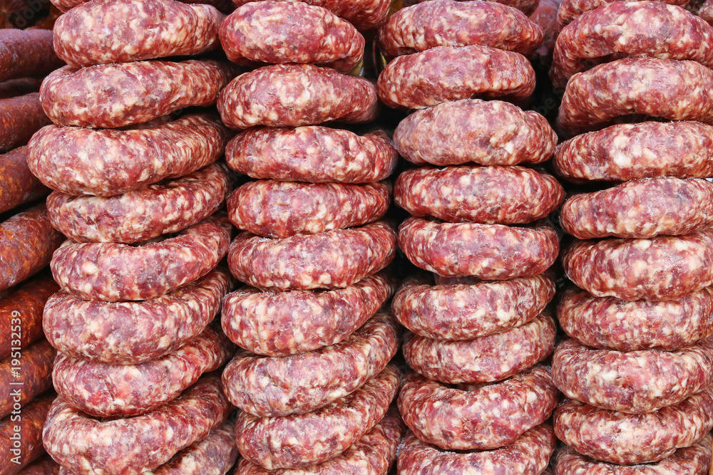 Rings of smoked pork sausage lie on the counter of a street vendor. Rings of smoked pork sausage lie on the counter of a street vendor.