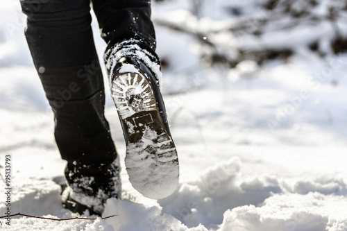 Woman hiking in snow boots and jeans on legs, women's winter shoes