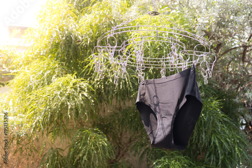Black underwear is hanging on the clothes rack